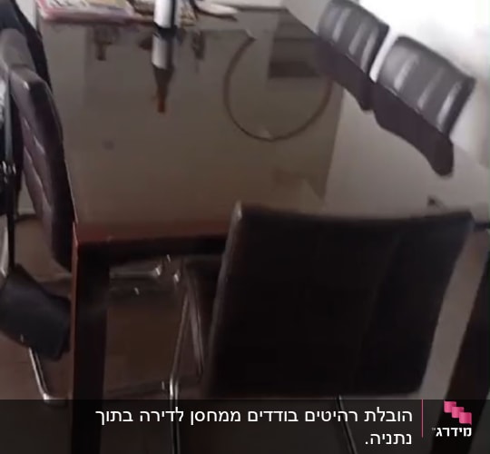 שולחן עם כיסאות ובקבוק יין במרכז